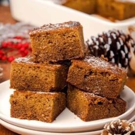 5 pieces of Old-Fashioned Gingerbread Cake on a white plate.
