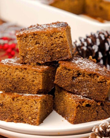 5 pieces of Old-Fashioned Gingerbread Cake on a white plate.