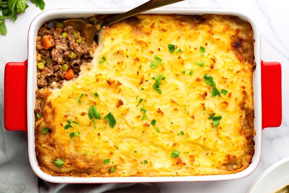Irish Cottage Pie in a baking dish after baking with a scoop taken out