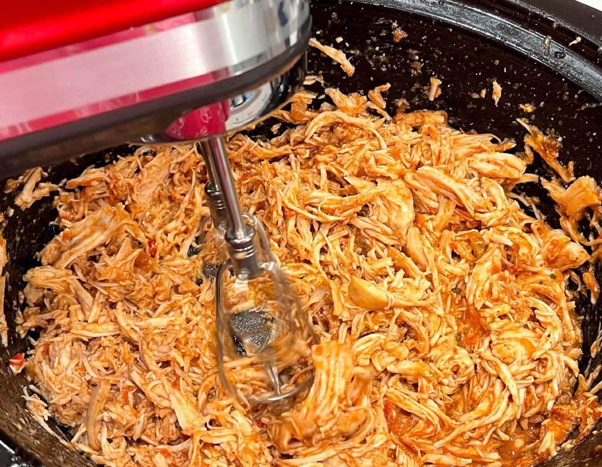 Salsa Chicken being shredded with a hand mixer