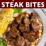 Steak Bites over mashed potatoes on plate with corn.