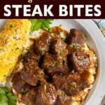 Steak Bites over mashed potatoes on plate with corn.