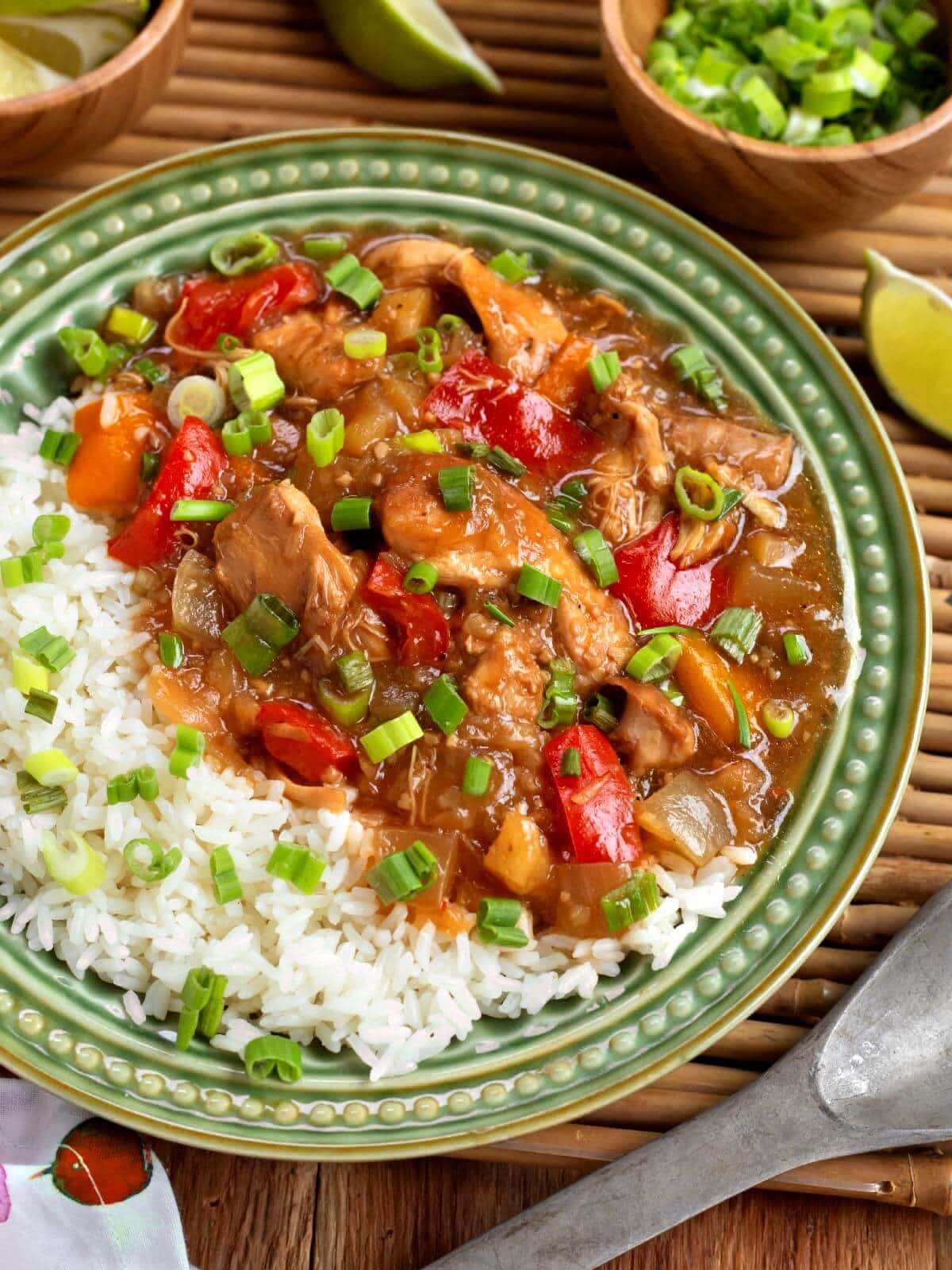 Slow Cooker Pineapple Chicken on a green plate with rice