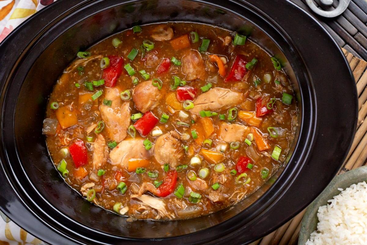 Slow Cooker Pineapple Chicken in a black crock