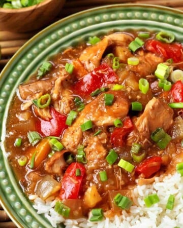 Slow Cooker Pineapple Chicken on a green plate with rice