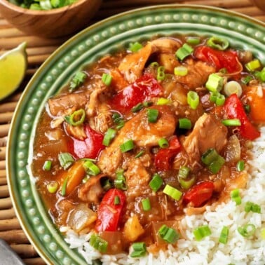 Slow Cooker Pineapple Chicken on a green plate with rice