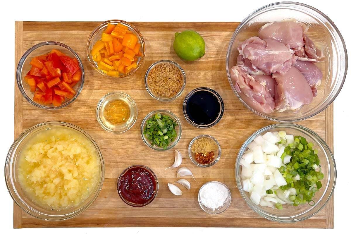 Slow Cooker Pineapple Chicken ingredients shot on a board