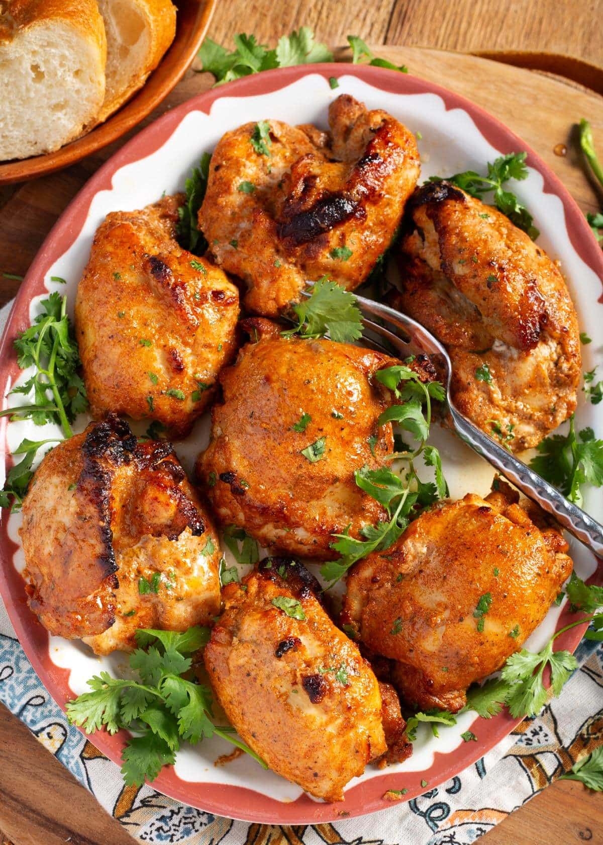 baked chicken thighs on a platter.