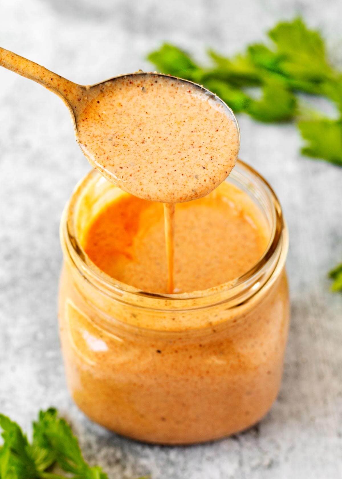 Southwest Buttermilk Chicken Marinade in a mason jar with a spoonful