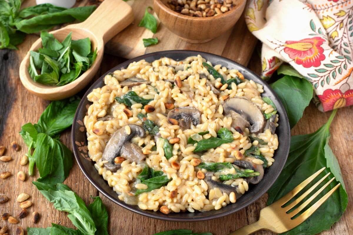 Spinach Mushroom Orzo in a bowl with garnishes