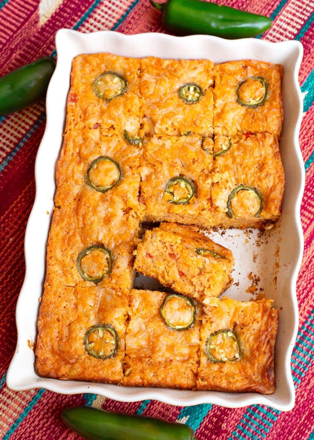 Tex-Mex Cornbread in a pan, sliced, with one slice on its side