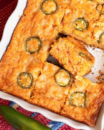Tex-Mex Cornbread in a pan, sliced, with one slice on its side