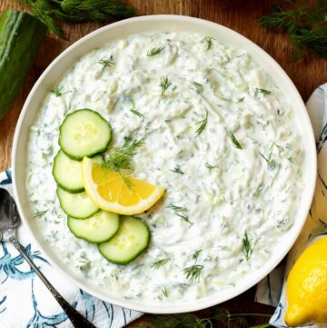 Tzatziki Sauce in a bowl with garnishes