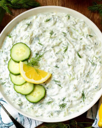Tzatziki Sauce in a bowl with garnishes