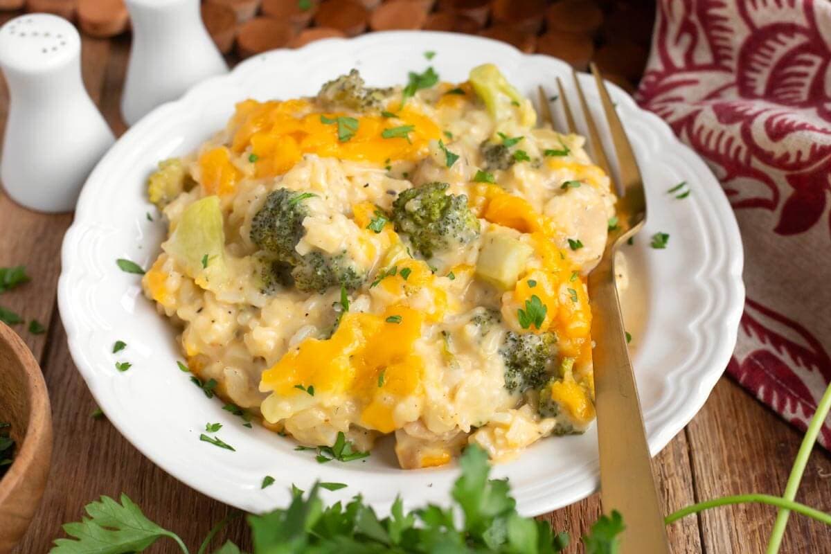 Cheesy Chicken Broccoli Rice Casserole on white plate with fork