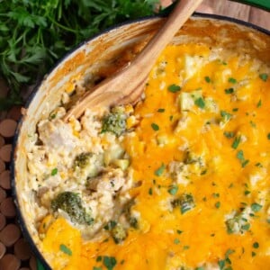 Cheesy Chicken Broccoli Rice Casserole in a pot with wood spoon