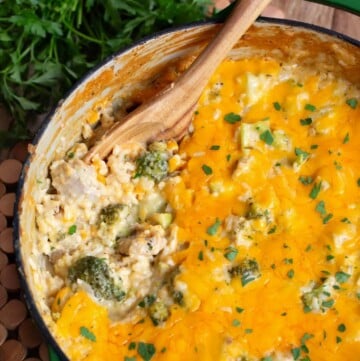 Cheesy Chicken Broccoli Rice Casserole in a pot with wood spoon