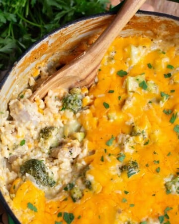Cheesy Chicken Broccoli Rice Casserole in a pot with wood spoon