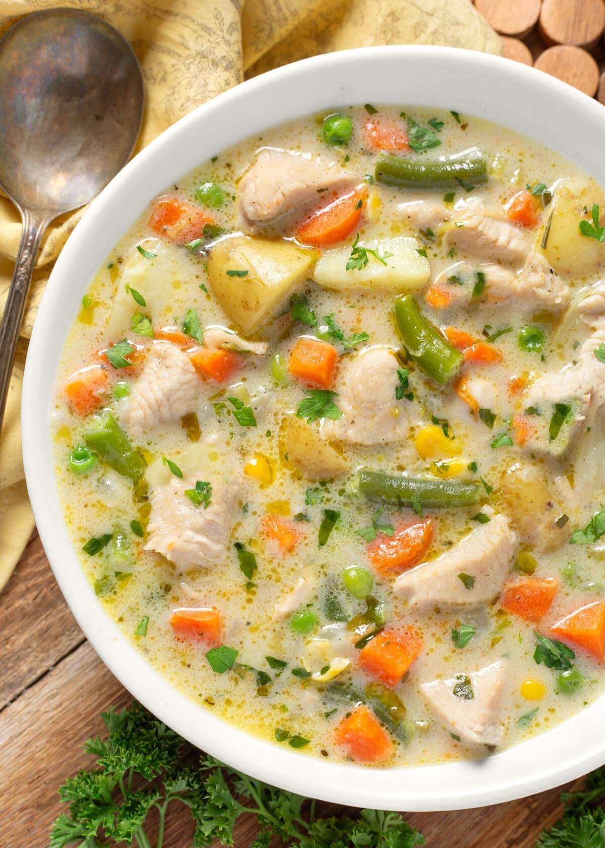 Chicken Pot Pie Soup in a white bowl closeup