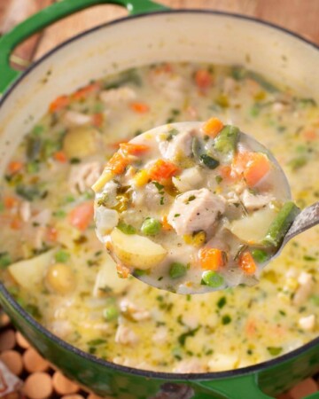 Chicken Pot Pie Soup in green pot with ladle