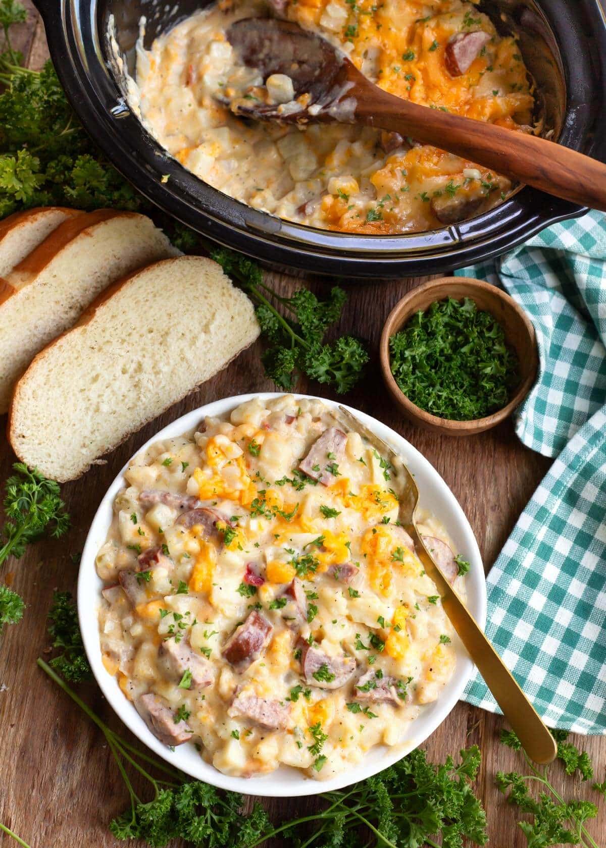 Crockpot Cheesy Potatoes with Kielbasa in a bowl and in a crockpot