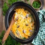 Crockpot Cheesy Potatoes with Kielbasa in a black crock