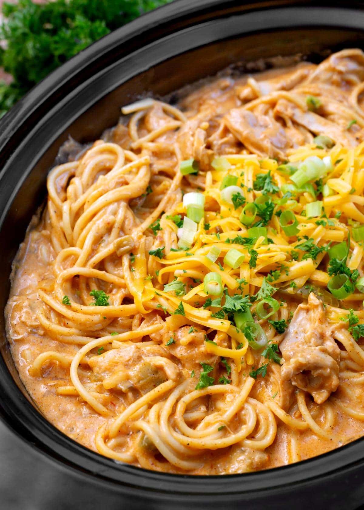 Crockpot Taco Ranch Chicken Spaghetti in a black crock