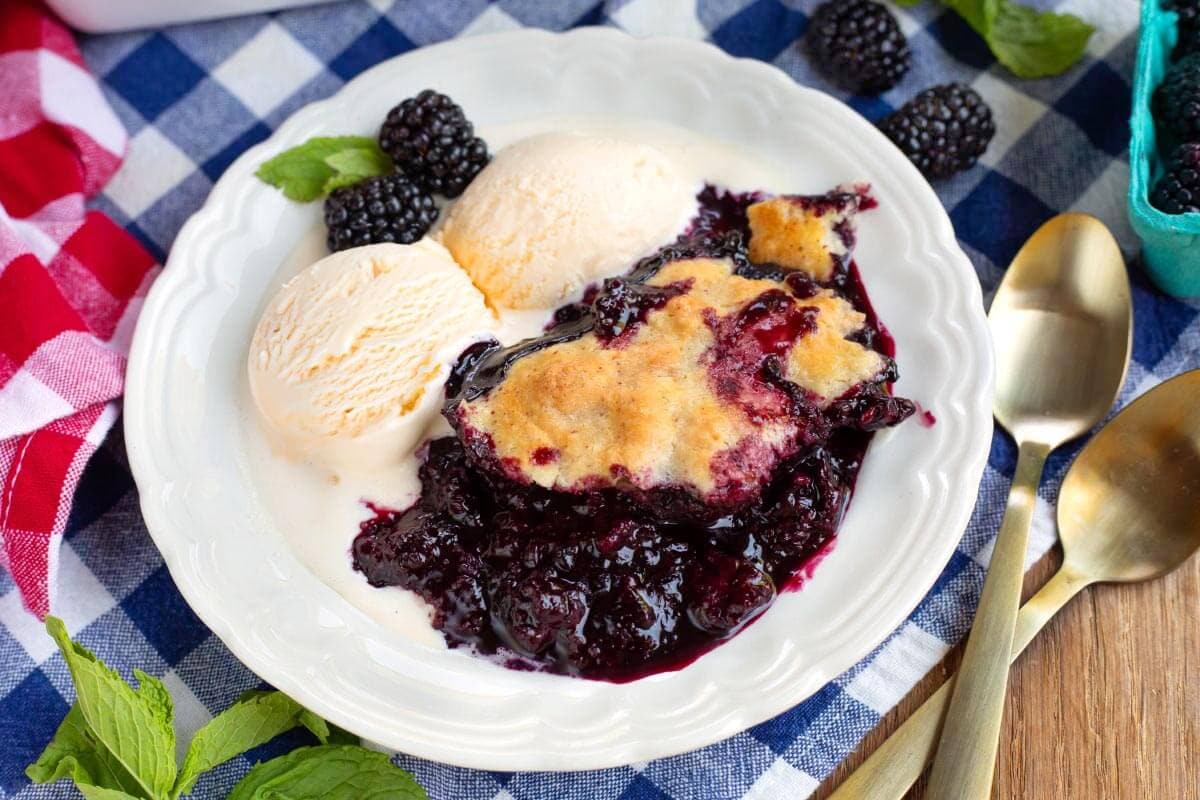 Homemade Blackberry Cobbler on a plate with ice cream