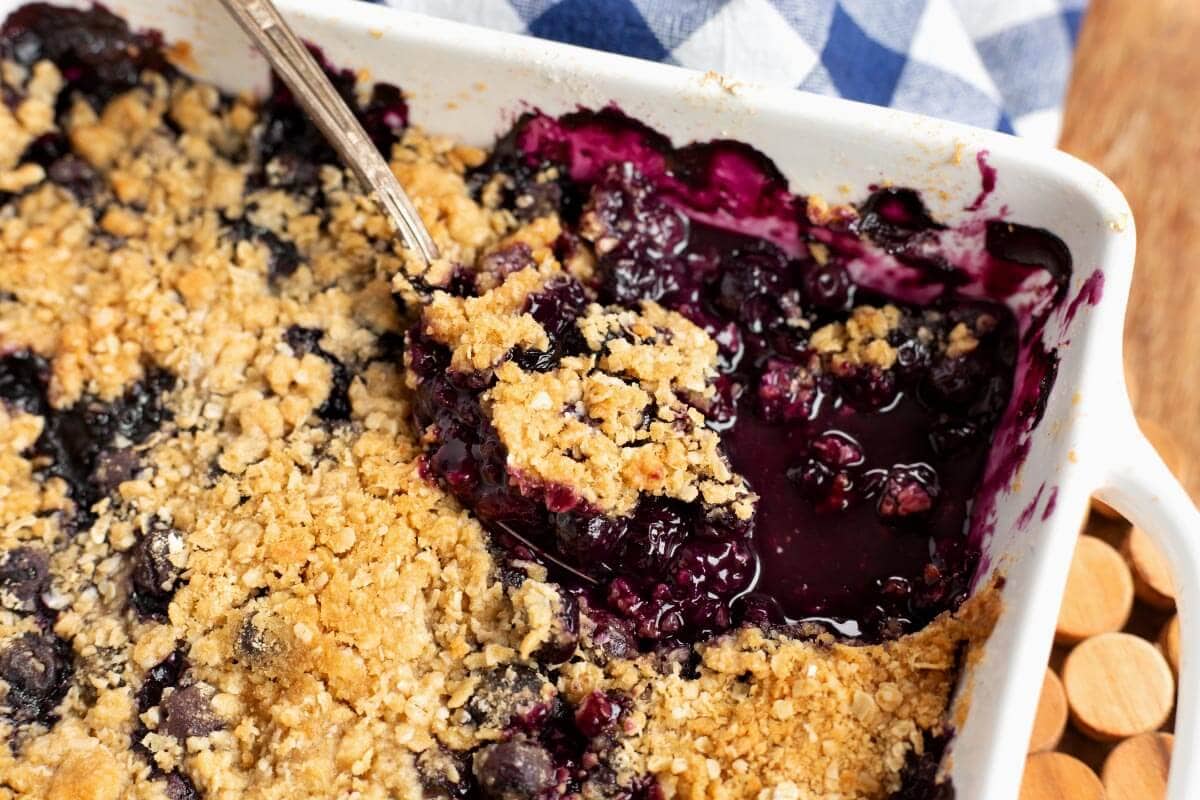 Easy Blueberry Crisp in baking dish with spoon