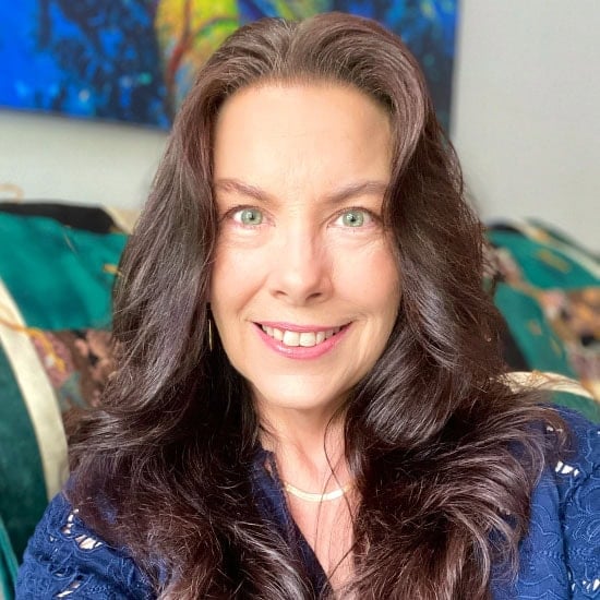 Sandy wearing a blue shirt, hair down