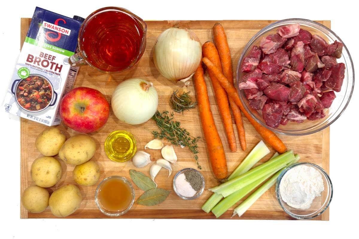 Crockpot Apple Cider Beef Stew ingredients shot on a board