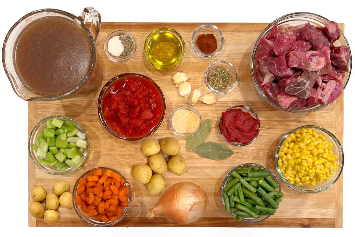 Crockpot Vegetable Beef Soup ingredients on a board