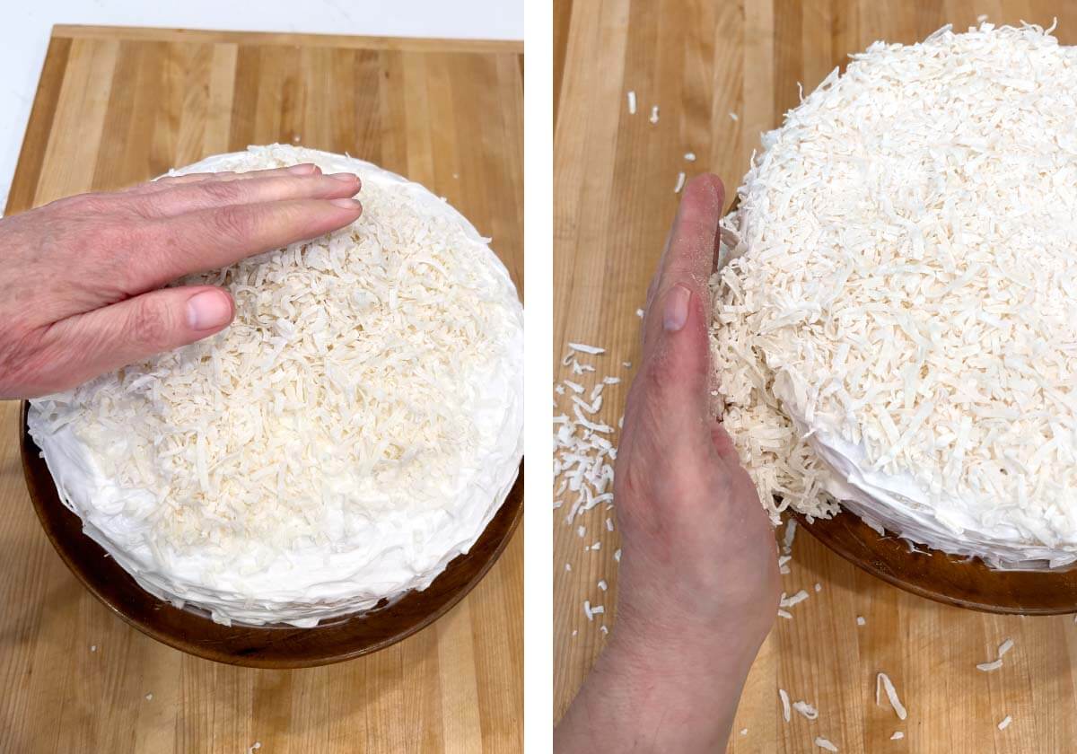 Pressing handfuls of shredded coconut onto frosted cake.