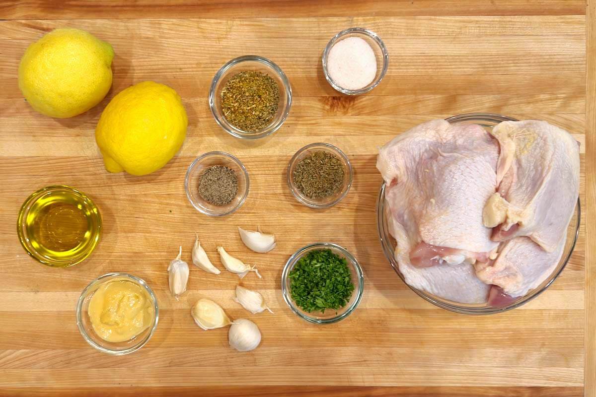 Greek Lemon Chicken Thighs ingredients shot on a board