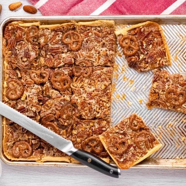 pecan slab pie on a sheet pan partially cut