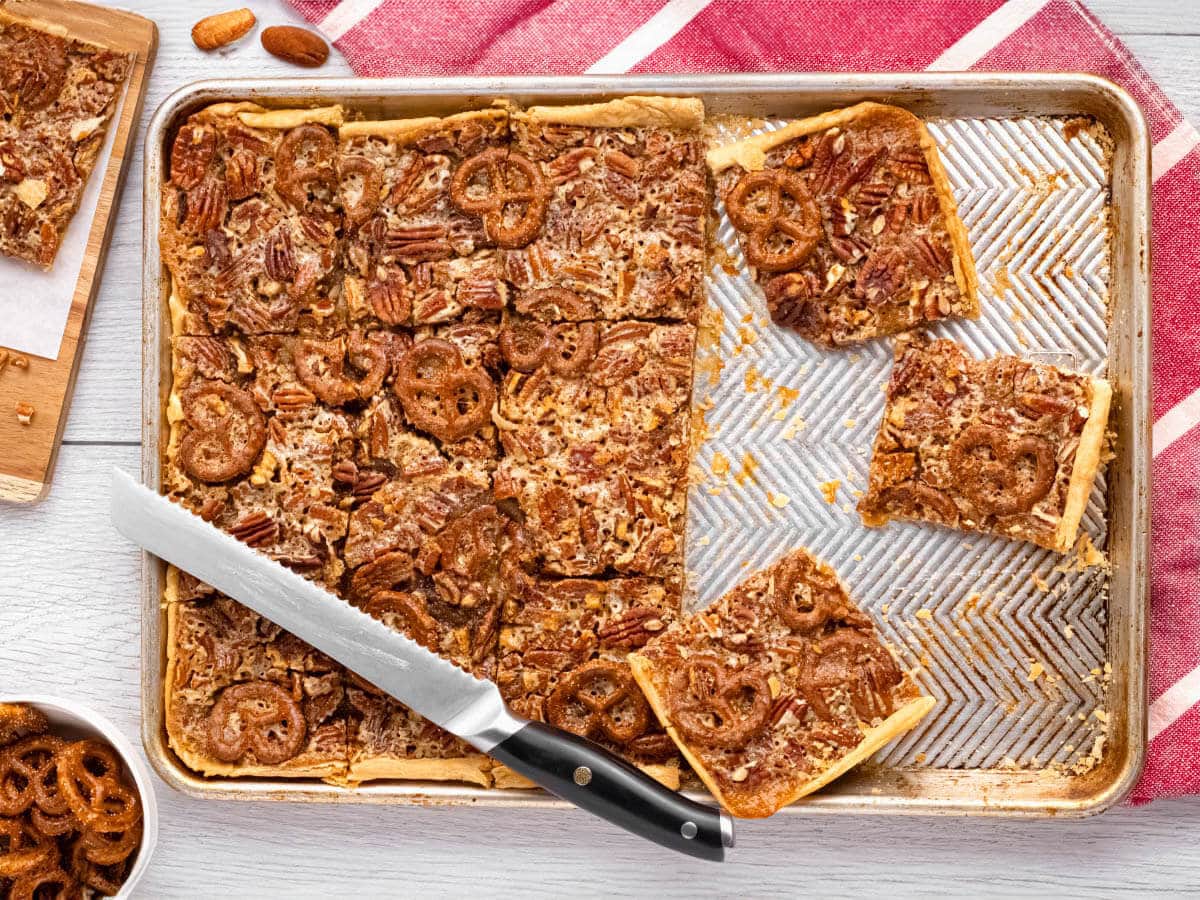 pecan slab pie on a sheet pan partially cut