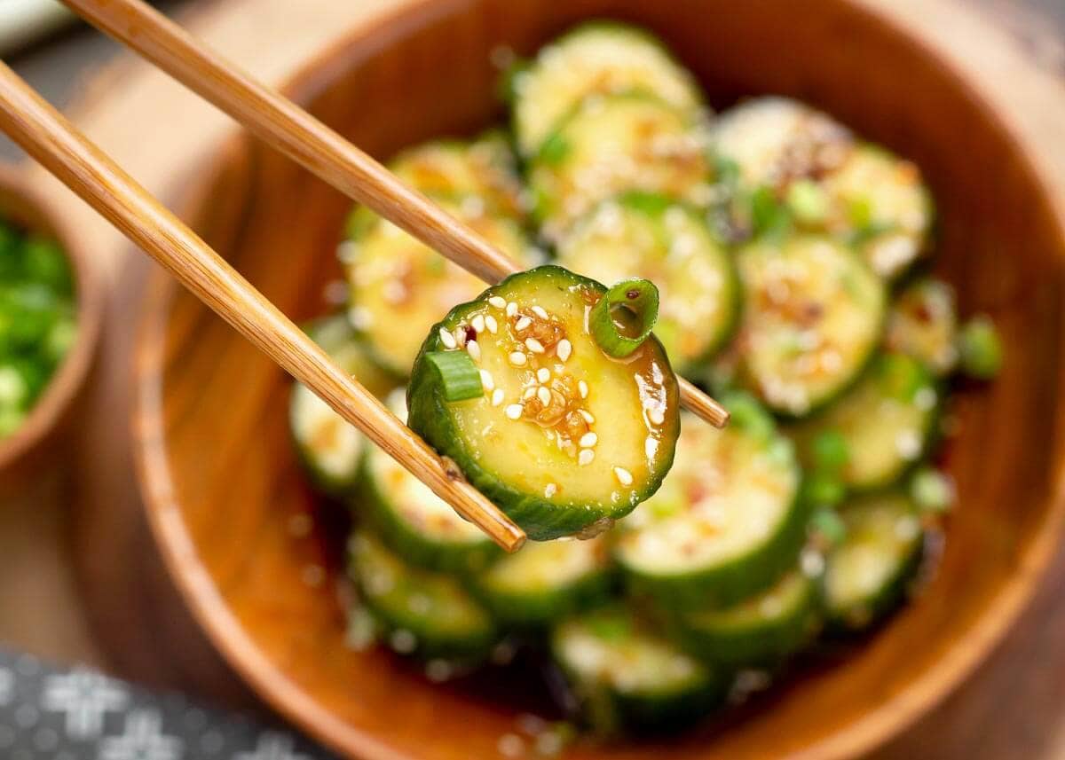piece of Asian cucumber salad in chopsticks