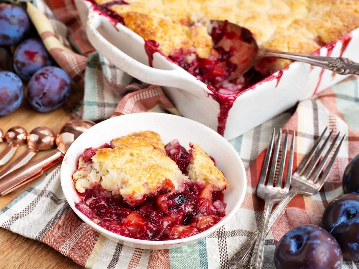 plum cobbler serving in a white bowl