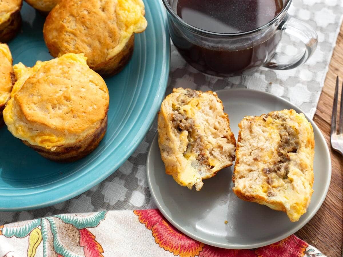 a sliced open egg muffin with sausage and cheese