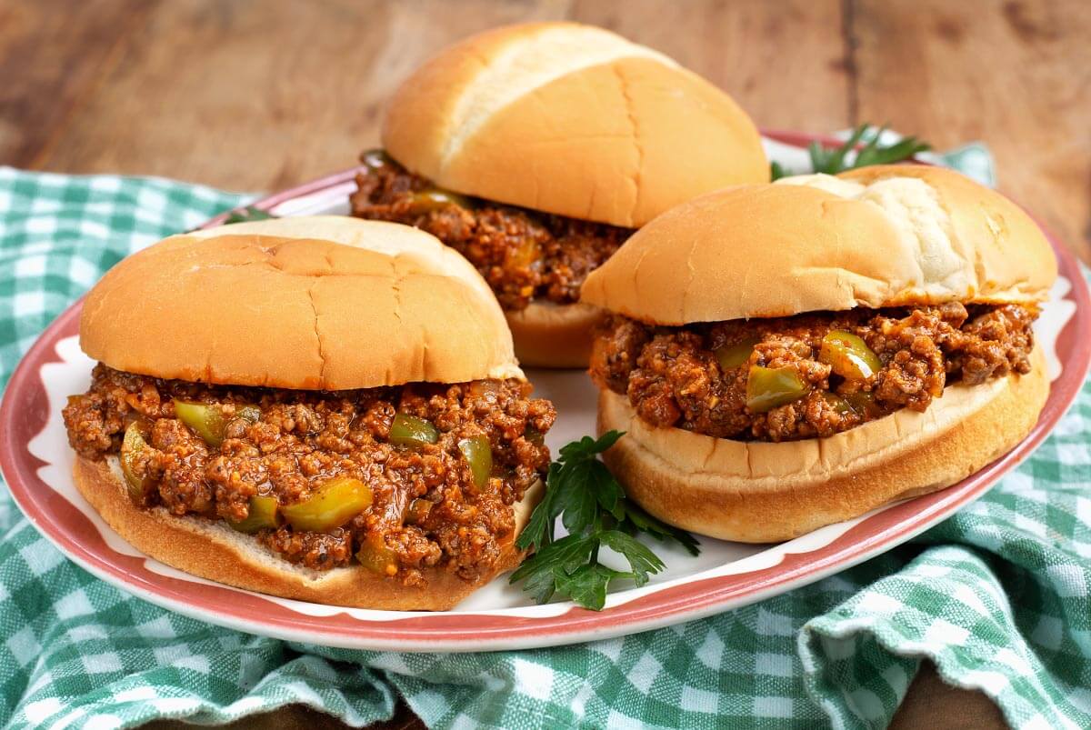 3 sloppy joes on buns on a plate