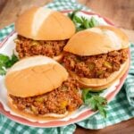 3 sloppy joes on buns on a plate