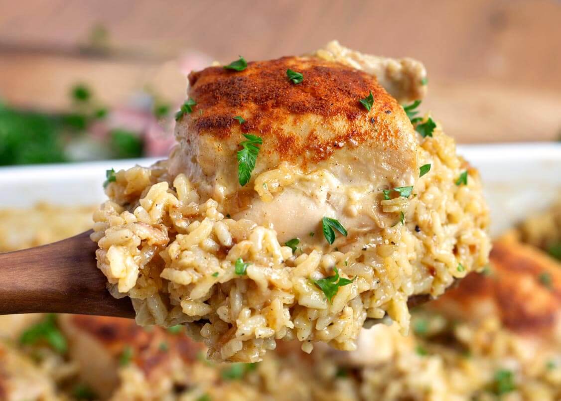 chicken and rice casserole on a wood spoon