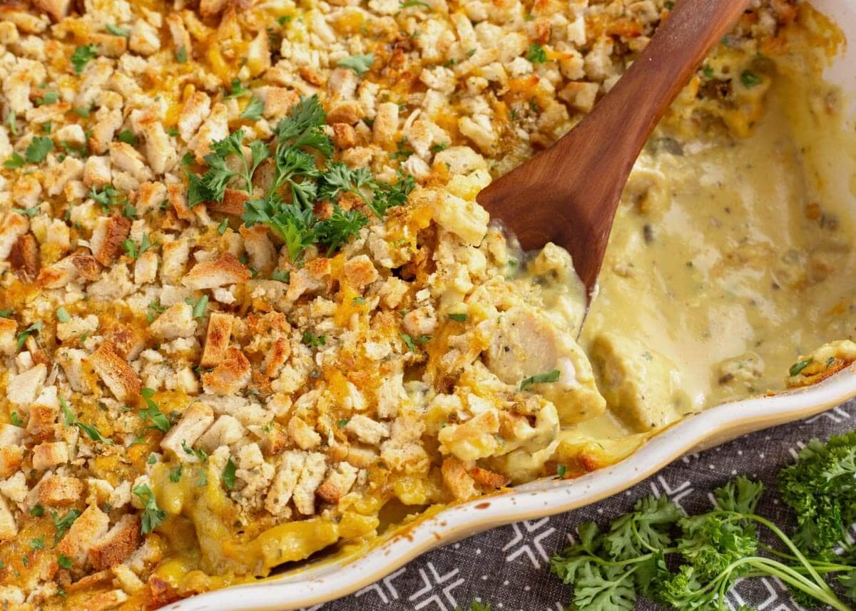 Close-up of creamy chicken and stuffing casserole with pieces of chicken beneath the crisp stuffing topping