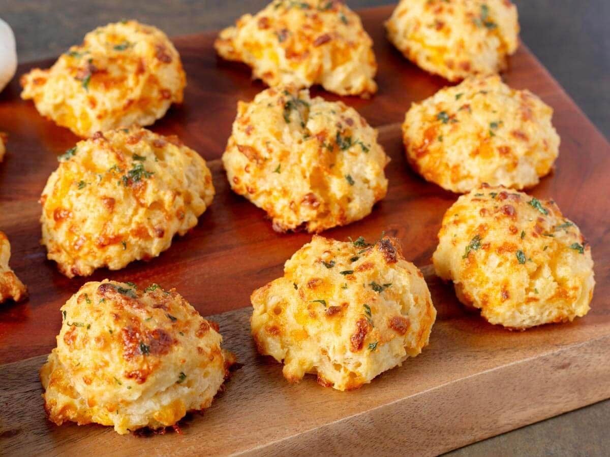 Garlic cheddar drop biscuits with golden tops brushed with garlic-parsley butter