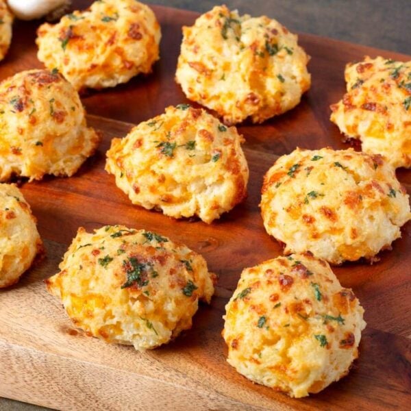 Garlic cheddar drop biscuits with golden tops brushed with garlic-parsley butter