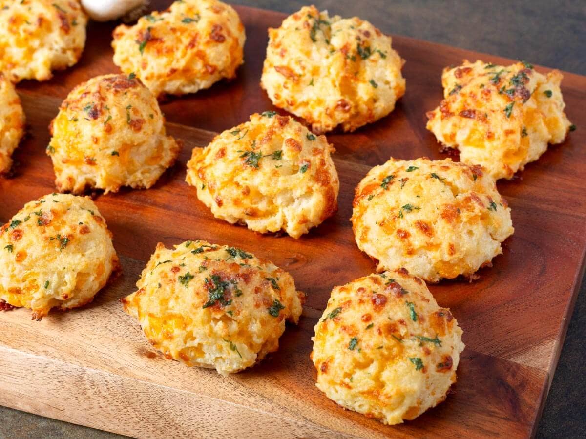 Garlic cheddar drop biscuits with golden tops brushed with garlic-parsley butter