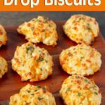 Garlic Cheddar Drop Biscuits are soft, cheesy, with crispy edges and savory garlic flavor! Made with cheddar cheese, buttermilk, and a garlic-parsley butter topping. No kneading, rolling, or cutting needed! A quick homemade biscuit recipe that's perfect with soup, chili, or a family dinner. simplyhappyfoodie.com, Cheddar Garlic Biscuits, Cheddar Drop Biscuits, Easy Biscuit Recipe, Homemade Cheese Biscuits, Garlic Butter Biscuits, Buttermilk Biscuits, Savory Biscuits, Easy Bread Recipe