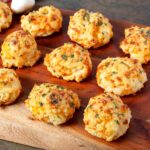 Garlic cheddar drop biscuits with golden tops brushed with garlic-parsley butter