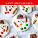 Melted snowman bark with peanut butter cup hats, candy eyes, red and green buttons, and pretzel arms.