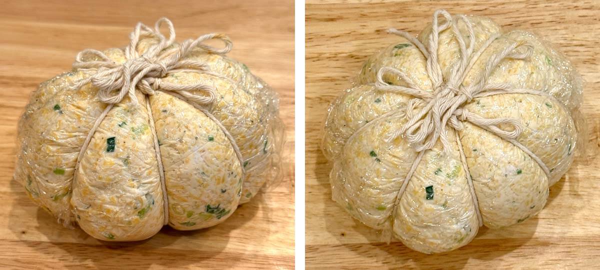 Pumpkin-shaped cheese ball wrapped in plastic and tied with kitchen twine, showing the defined ridges before chilling.